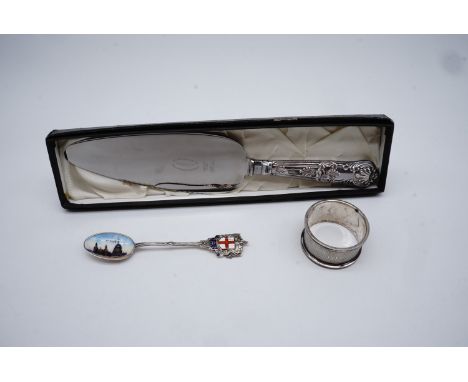 A silver 1919 enameled London souvenir tea spoon together with a silver napkin ring and a silver handled Viner's cake slice