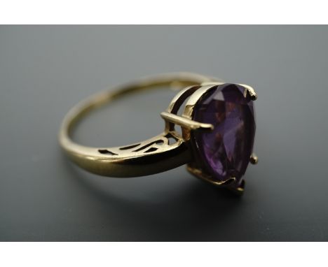 An amethyst and 9 ct gold ring, the pendeloque cut stone of approx. 12 mm x 8 mm claw set on 9 ct gold, Q/R