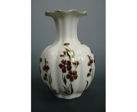 A Zsolnay of Pecz hand-enamelled and gilt-enriched porcelain vase, of organic lobed form with slender neck and wavy everted r