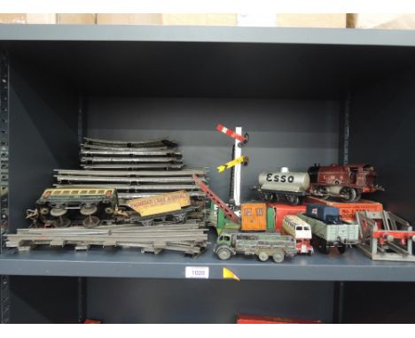 A shelf of Hornby 0 gauge including a clockwork 0-4-0 LMS locomotive 2115, boxed L456, rolling stock, accessories and track a