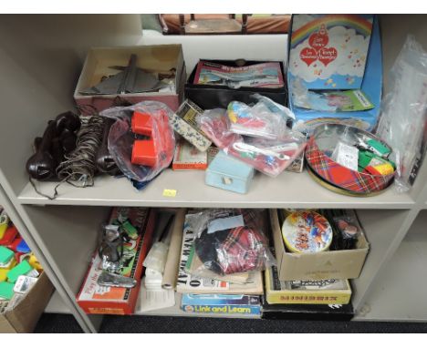 Two shelves of mixed vintage toys and games including Minibrix, Viewmaster, Bakelite telephone, Jokari, Over She Goes etc