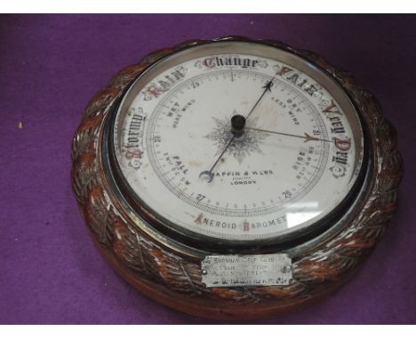 A Victorian oak frame circular aneroid barometer labelled for Mappin & Webb with HM silver plaque for Burnham Golf Club 1894