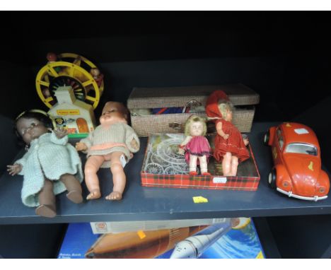 A shelf of mixed toys including Tonka Beetle car, Pedigree and similar dolls and accessories etc