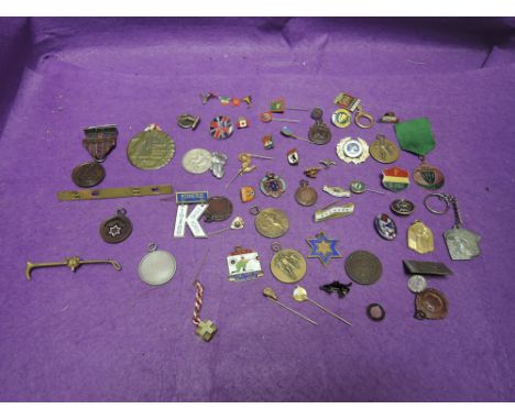 A collection of sporting medals, pin badges, stick pins, etc, relating to World cup visits and athletics etc 