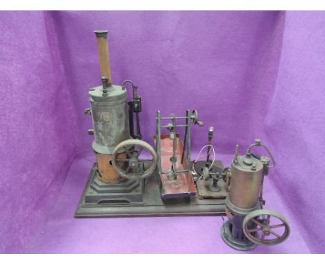 A Early Marklin & Cie vertical live steam engine with flywheel with a similar accessories on plinth, height from base 16' and