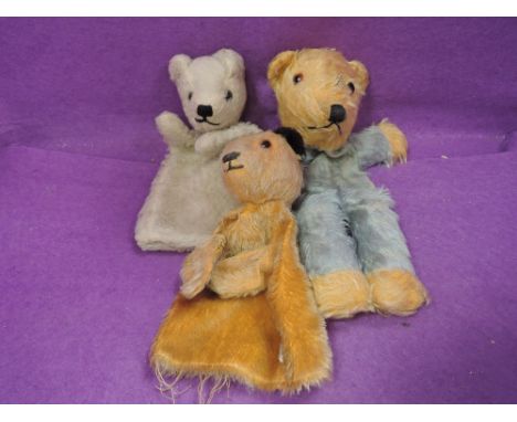 A 1960's Chad Valley Sooty hand puppet a similar Sooty hand puppet in white and a teddy bear without filling