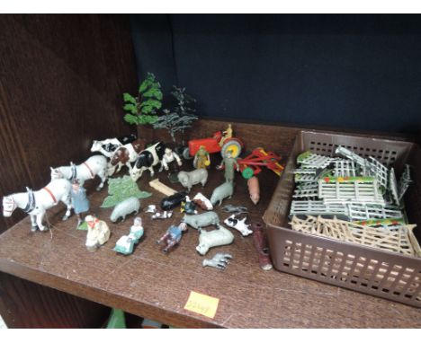A selection of Britains lead farm workers, animals and accessories along with a Dinky diecast Massey Harris tractor and trail