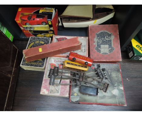 Five vintage wooden jigsaws including Cunard, a small selection of 0 gauge rolling stock and track along with a woden model p