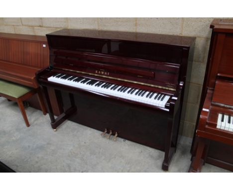 Kawai (c2014)  A Model K-200 upright piano in a bright mahogany case; together with a stool. 