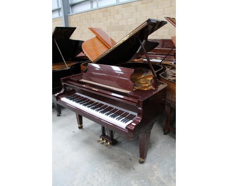 Schimmel (c1985) A 6ft 11in Model K grand piano in a bright ebonised case on square tapered legs, together with an 'A' frame.