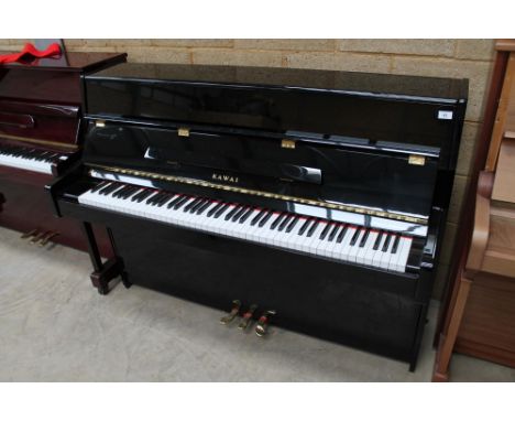 Kawai (c2005) A Model K-15E upright piano in a bright ebonised case; together with a matching stool. 