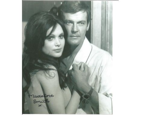 Madeline Smith signed 10x8 b/w photo alongside Roger Moore. she played the Bond girl Miss Caruso in the post-opening titles s