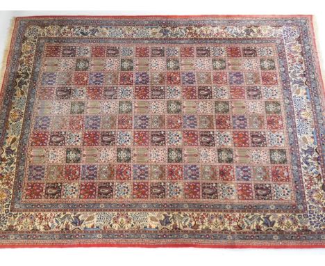 Bakhtiar carpet, centred with a geometric trellis with floral and traditional motifs within a border of animals and birds in 