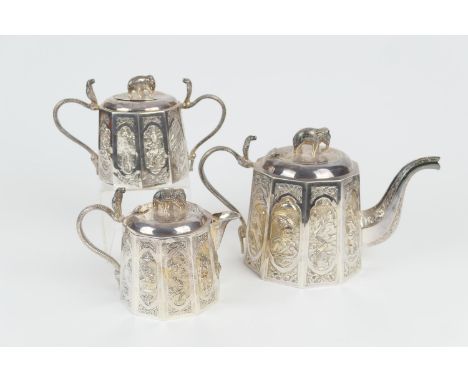 Indian white metal three piece tea service, circa 1900, comprising a lidded teapot with elephant finial and cobra handle, dec