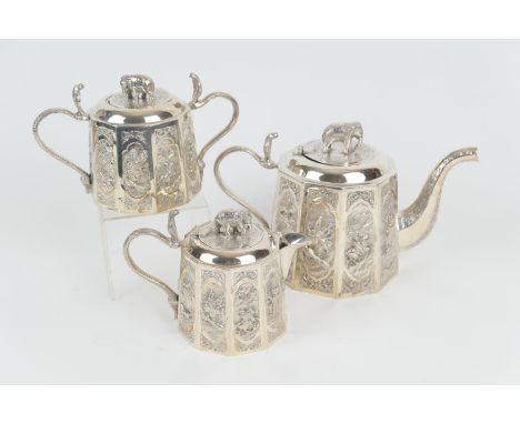 Indian white metal three piece tea service, circa 1900, comprising lidded teapot, with elephant finial and cobra handle, face