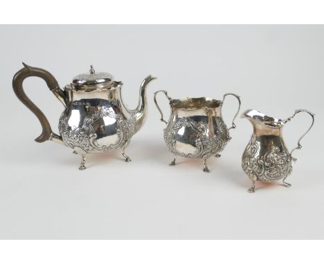 Late Victorian silver three piece tea service, maker TH, Birmingham 1895, comprising baluster teapot, repousse decorated with