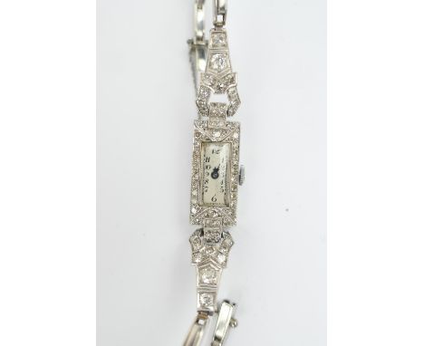 Vintage platinum and diamond set lady's cocktail watch, circa 1925, slender rectangular dial, 12mm, silvered and with Arabic 