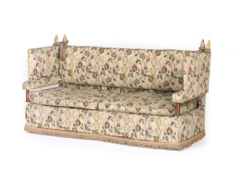 Traditional tapestry fabric upholstered knole settee, with turned mahogany forearms, raised on original brass wheel castors, 