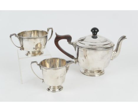 George VI silver three piece tea service, London 1937, plain form, the teapot with replaced ebonised finial and wooden handle