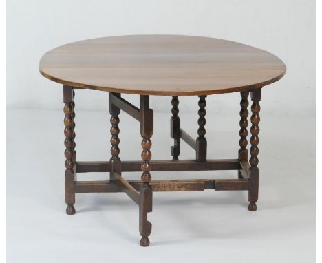 Oak bobbin turned gateleg table, the top with two demi-lune drop leaves, over a single pullout gate, stretcher base, width 12