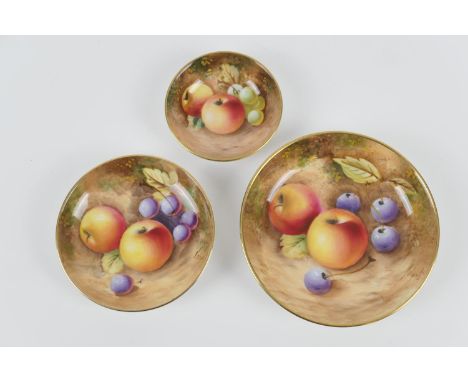 Three Royal Worcester fruit decorated pin dishes, the largest decorated with apples and cherries, signed, 11cm diameter; the 