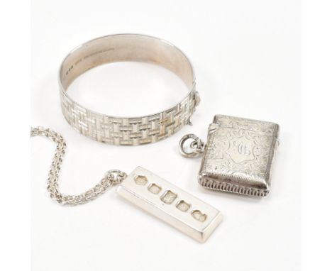An assorted collection of hallmarked silver jewellery. The lot to include an engine turned bangle, hallmarked for London 1978