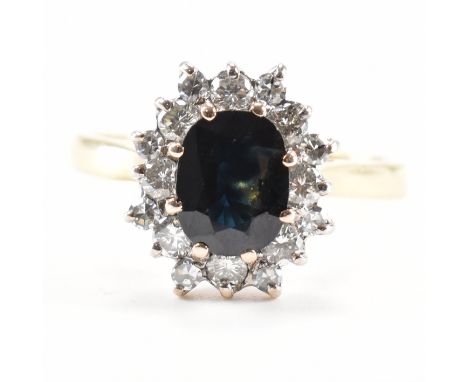 A hallmarked 18ct gold sapphire and diamond ring. The ring being set with an oval cut sapphire surrounded by a halo of round 