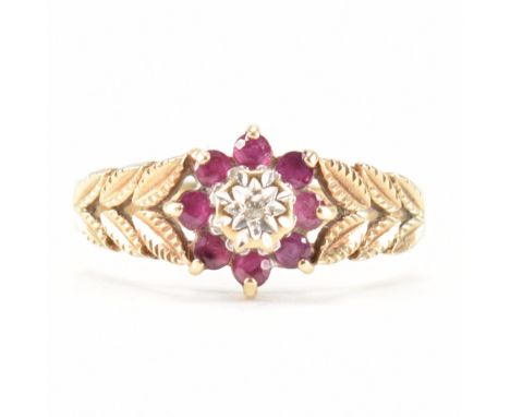 A hallmarked 9ct gold ruby and diamond ring. The ring being set with a diamond to the centre with a halo of round cut rubies 