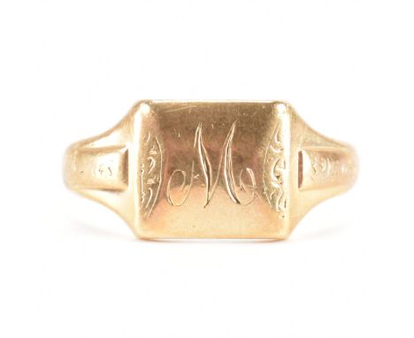 An A/F hallmarked 9ct yellow gold signet ring. The ring having a rectangular head with initial M inscribed to scrolling etche