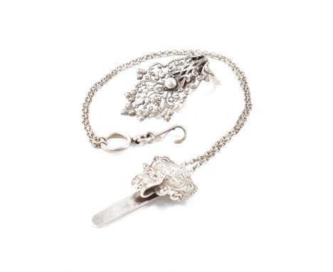 A 19th Century antique silver plated chatelaine together with a white metal dress clip. The chatelaine having moulded garden 