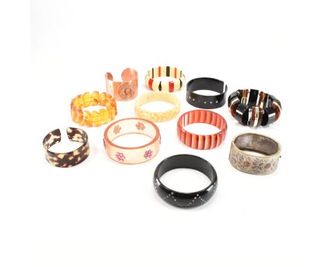 A collection of vintage 20th Century bangle bracelets. The lot to include a faux amber bracelet, antique silver plated bangle