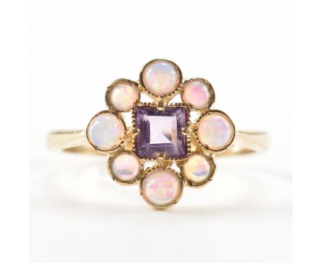 A hallmarked 9ct gold amethyst and opal cluster ring. The ring being set with a square cut amethyst to the centre surrounded 