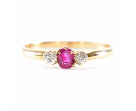 An A/F hallmarked 18ct yellow gold diamond &amp; ruby three stone ring. The ring having a central oval cut ruby flanked by a 