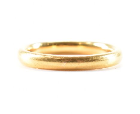 A hallmarked 22ct yellow gold band ring. The wedding band style ring of rounded D form, hallmarked for Birmingham 1953, maker