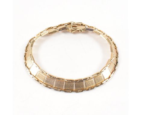 A vintage 9ct gold link bracelet with twin clasp. Each link with engine turned decoration. Sponsors mark S&P, stamped 9ct. To