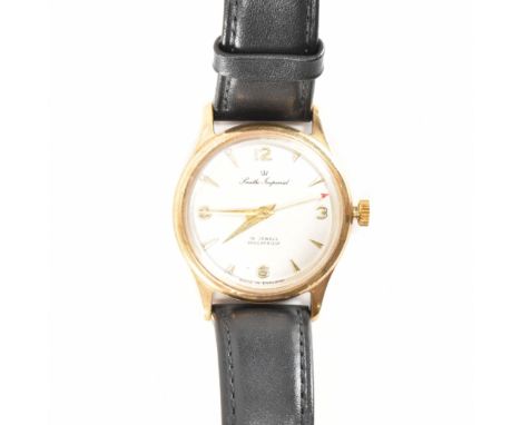A hallmarked 9ct yellow gold Smiths Imperial wrist watch. The watch having a circular silvered dial with gilt gold tone Arabi