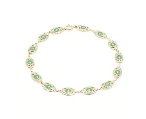 An early 20th Century Edwardian gold and enamel panel bracelet. The bracelet having pierced details with green enamel. Later 