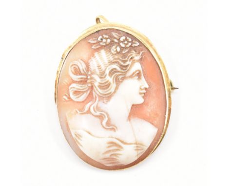 A vintage gold mounted cameo brooch pendant. The pendant featuring a carved shell portrait of a classical female set within a