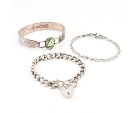 A group of three silver bracelets. The lot to include a silver hallmarked bangle with abalone set clasp (hallmarked Sheffield