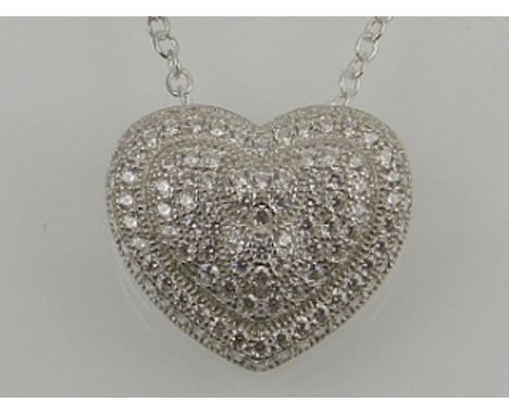 A silver and cubic zirconia heart-shaped pendant, on a silver chain. 