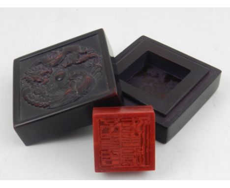 A Chinese soapstone seal, in a inkstone case, decorated with dragon and phoenix chasing a flaming pearl, bears character mark