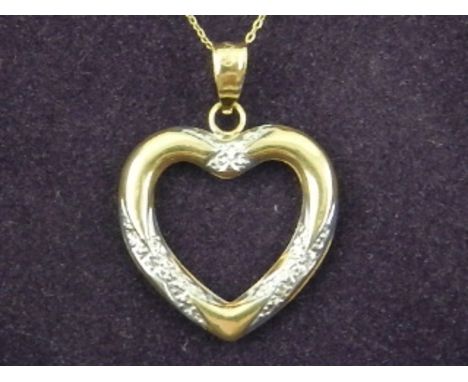A 9 carat yellow gold heart-shaped pendant suspended on a 9 carat yellow gold chain. 