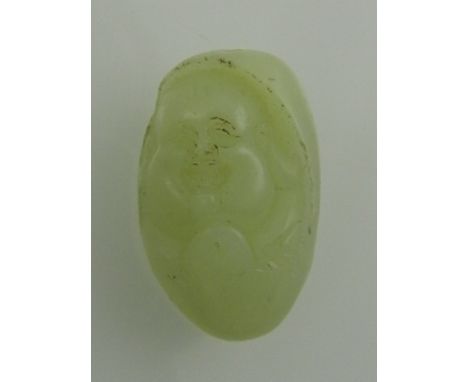 A white jade carving of a laughing Buddha face. H.3.5cm
