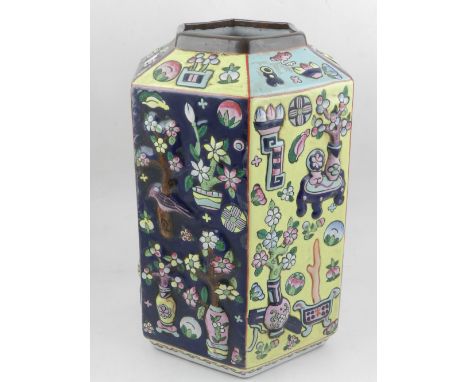 A Chinese polychrome decorated hexagonal vase, having raised decoration of vases, fruits and foliage, bears seal mark to base