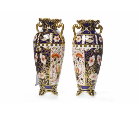 PAIR OF ROYAL CROWN DERBY 'IMARI' PATTERN TWIN HANDLED VASESof tapering circular form, on four bracket feet, decorated in the