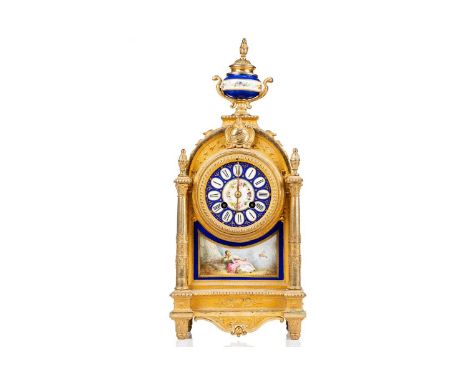A Louis XVI-style gilt metal cased 8-day mantle clock of architectural arched form, with Sevres style bleu nouveau porcelain 