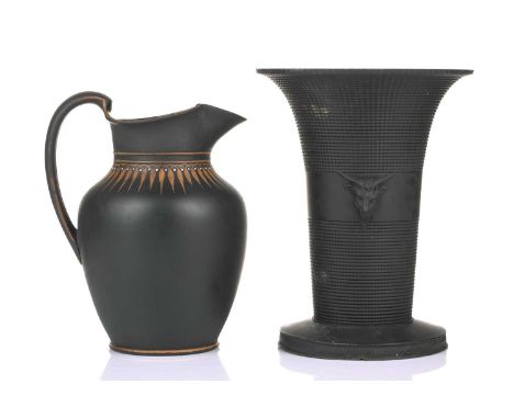 An early 19th century Wedgwood black basalt vase, of flared rim form with twin satyr mask decoration, on a spreading circular