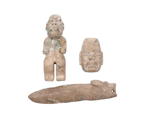 A carved jade Olmec standing figure with pierced head, in a crouching stance with arms raised at waist height, 16 cm high, to