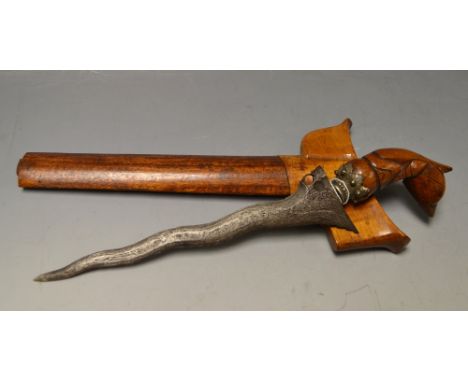 A Malayan Kris and scabbard, the wavy engraved 17cm blade, hardwood grip and scabbard, 29cm long 