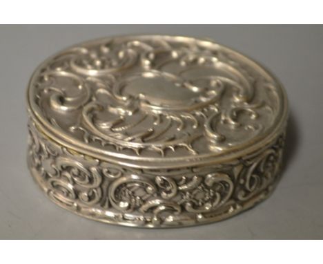 A Continental silver pill/snuff box, reposse decorated with foliate scrolling